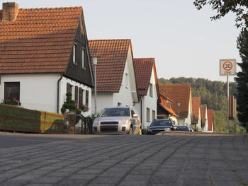 Cars parked on road against clear sky