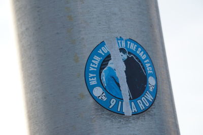 Close-up of information sign on wall