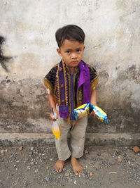 Cute girl standing against wall