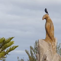 Low angle view of statue against sky