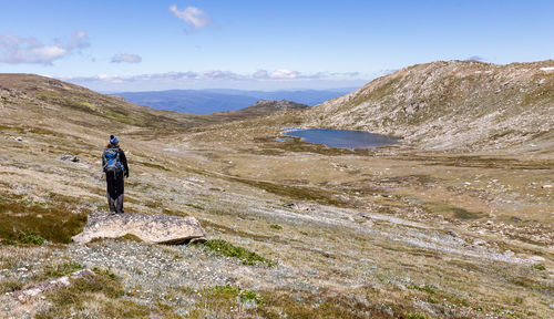 Rear view of person looking towards mountain