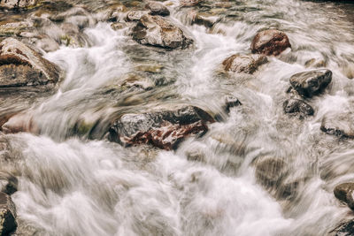 Stream flowing through rocks in sea