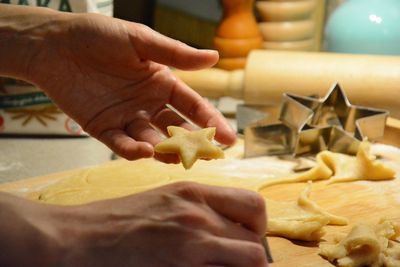 Human hand preparing cookies