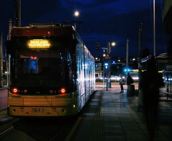 Tram on road at night