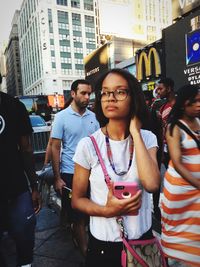 Portrait of a young woman looking at city