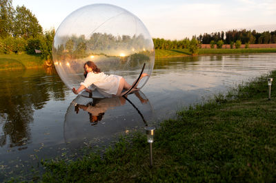 Rear view of man standing in lake