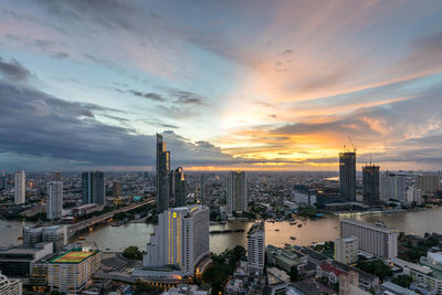 High angle view of modern buildings against sky during sunset