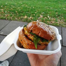 Cropped image of hand holding burger