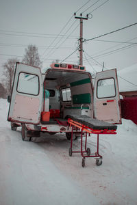 View of ambulance on snow covered land during winter