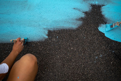 Low section of woman standing in water