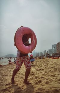 Rear view of man standing on beach