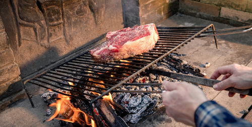 Italian roasted steak on a barbecue grill. appetizing piece of meat cooking on fire. bbq concept.