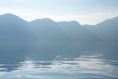 Scenic view of sea and mountains against sky