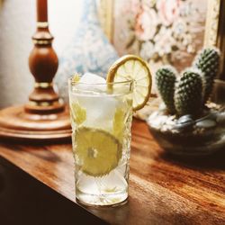 Close-up of clear gin drink on vintage table