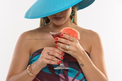 Midsection of a woman drinking glass