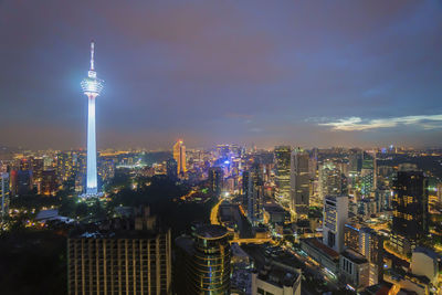 Illuminated cityscape against sky at night