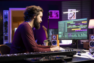 Side view of man working at office