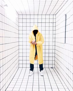 Full length of a man standing on tiled floor