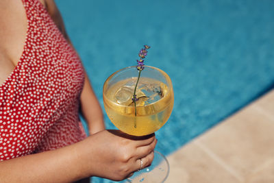 Midsection of woman holding water