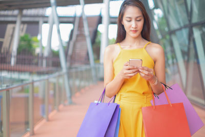 Young woman using mobile phone outdoors