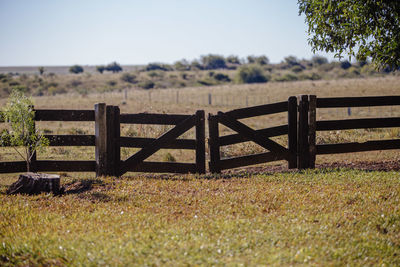 Fence on field against sky