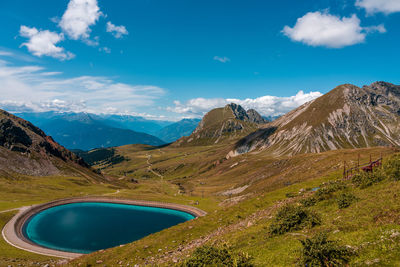 Scenic view of lake and mountains against blue sky