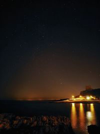 Scenic view of sea against sky at night