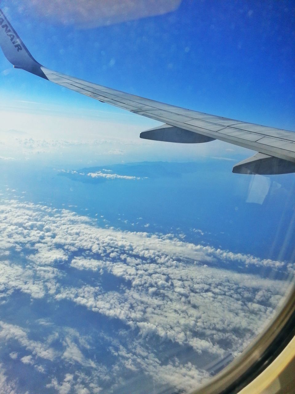 airplane, transportation, air vehicle, aircraft wing, mode of transport, flying, aerial view, part of, cropped, travel, journey, public transportation, mid-air, sky, vehicle interior, on the move, scenics, airplane wing, landscape, aeroplane