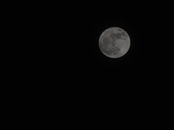 Low angle view of moon against clear sky at night