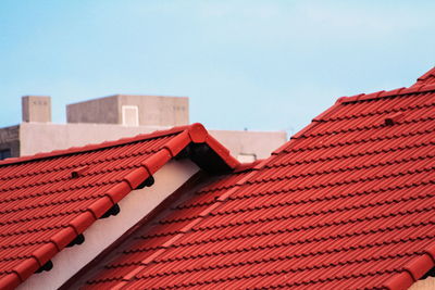 Tilt image of house roof against clear sky