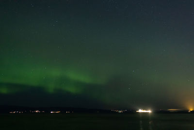 Scenic view of sea and aurora at night