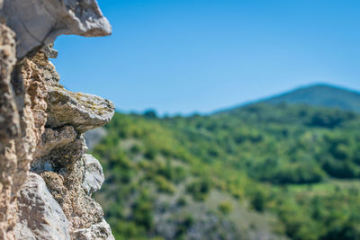 Scenic view of rocks against clear blue sky