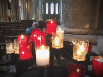 Close-up of illuminated tea light candles on table