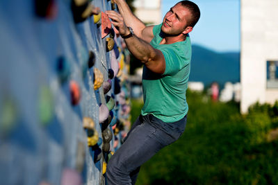 Low angle view of young man exercising in city