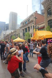 People on street against buildings in city