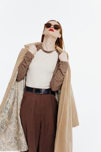 Portrait of woman wearing sunglasses against white background