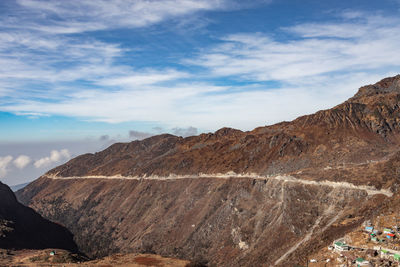 Himalayan breathtaking landscape with bright blue sky and twisty adventurous valley road