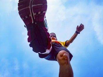 Low angle view of man standing against sky