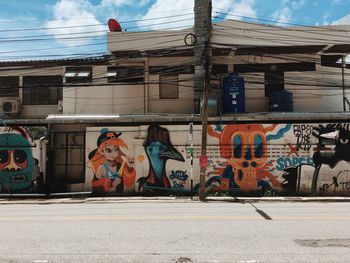 Graffiti on road against buildings in city