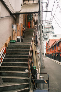 Low angle view of staircase amidst buildings in city