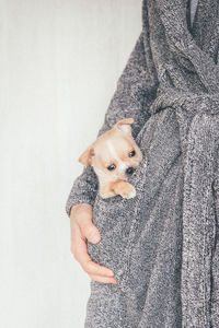 Portrait of woman man with dog in her pocket 