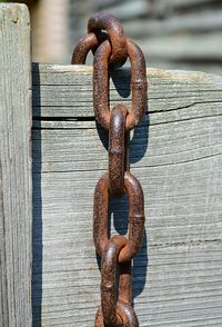 Close-up of metal chain on wood