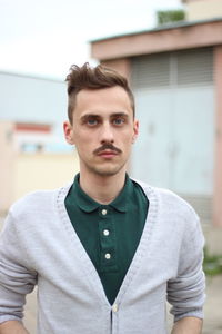 Portrait of man looking away while standing outdoors