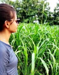 Side view of woman looking away on field