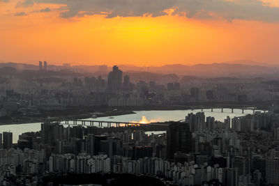 High angle view of seoul city and han river against sky during sunset