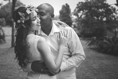 Man kissing woman while standing on road