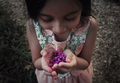 High angle view of cute girl holding flower