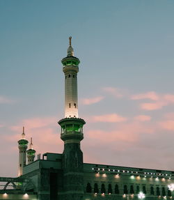 Low angle view of alharam almakki against sky during sunset