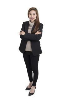 Portrait of smiling young woman against white background