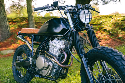 Closeup of beautiful vintage custom motorcycle parked on the field